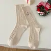 Calcetines de mujer de caña media otoño e invierno patrón de cáñamo calcetines de Navidad bordado de muñeco de nieve moda todo a juego calcetines de felpa Zhuji