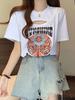 Camiseta de manga corta con hombros descubiertos estilo americano para mujer, diseño Sense Niche, nueva camiseta de verano holgada, ahuecada y adelgazante de algodón puro.