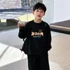 Camiseta de manga larga de algodón puro para niños, versátil top de dibujos animados nuevo para primavera y otoño 2026, camiseta básica para niños, ropa para niños talla mediana y grande