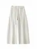 Foto real de la nueva colección de otoño 2026: pantalones de mujer de cintura alta con pierna curva y adornos de pedrería, pantalones de pierna ancha, pantalones casuales de pierna recta