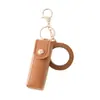 Mini llavero de lipstick portátil, bolsa redonda de cuero con espejo de maquillaje, accesorio para niñas, colgante de bolsa de espejo de maquillaje portátil