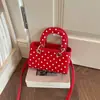 Bolso de lunares de nicho de alta gama para mujer, nuevo modelo de otoño 2026, súper popular para el trabajo, bolso de mano pequeño, bolso de hombro y cruzado