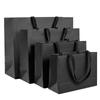 Bolsa de Papel Grueso Blanco y Negro Bolso de Mano Logotipo Personalizado Bolsa de Embalaje para Tienda de Ropa Regalo de Ropa Personalizado de Alta Gama y Fuerte
