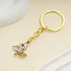 Pendente de Aço Inoxidável Cruzado Mais Vendido Nova Cor de Esmalte Chaveiro Borboleta Banhado a Ouro Cravejado com Strass Ornamento de Pingente de Bolsa
