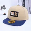 Gorra de Hip-Hop para Niños 2026 Primavera Nueva Gorra de Béisbol con Visera Moda Coreana Cara Sonriente Logo K Gorra de Baile Callejero Transfronterizo