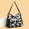 Moda transfronteriza fabricantes de comercio exterior al por mayor explosiones estampado de letras moda simple bolsa de mano para mujer hombro diagonal mochila
