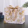 Bolsas de regalo transfronterizas con diseños florales y cintas, bolsas de embalaje de alta gama, bolsas de regalo para fiestas, bolsos de mano, bolsas de embalaje para ropa