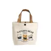 Bolsa de Lona con Oso Estilo Nuevo 2025 Bolsa Portátil para Almuerzo Bolso de Mano Artístico de Dibujos Animados Lindos Bolsa de Regalo para Mujeres