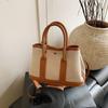 Bolsa de balde portátil de alta costura feminina 2025 nova de primavera bolsa tote de lona versátil bolsa tiracolo popular