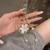 Correa de teléfono con perlas de flor de iris blanco Accesorio de moda coreano llavero para mujer