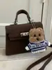 Bolsa Kelly de Venda Quente Transfronteiriça para Mulheres 2025 Nova Moda Versátil Alta Qualidade Nicho Bolsa de Mão Bolsa de Ombro Transversal