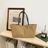 Nuevo bolso de lona simple para mujer, otoño de 2026, bolso de hombro de gran capacidad para el trabajo, bolso de mano de color liso con sensación relajada