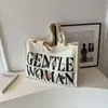 Bolso de hombro texturizado casual de gran capacidad para mujer, nuevo 2023, bolso de lona con letras pintadas y estampadas
