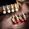 Brincos de pérola com nó cravejado de diamantes estilo francês para mulheres, estilo socialite elegante, clipes de orelha espirais, brincos de design único e estiloso