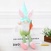Decoraciones de Pascua Nuevas Transfronterizas Adornos de Duende de Piernas Largas en Postura Sentada Muñeca de Duende de Dibujos Animados Sosteniendo Muñeca de Rábano