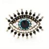 Broche de moda europeo y americano con personalidad, broche de ojo de diablo creativo retro, broche de aleación de diamante exagerado, venta al por mayor