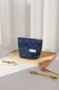 Nueva Bolsa de Maquillaje de Tela con Lazo Retro de Mezclilla de Nicho para Niñas, Bolsa Portátil de Almacenamiento Tipo Almohada para Cuidado de la Piel