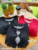 Camiseta Negra con Lazo Falso de Dos Piezas Manga Larga para Mujer Primavera 2026 Corte Ajustado Capa Interior Diseño de Encaje Patchwork Top