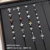 Nuevos y modernos aretes de cruz con diamantes completos Jiuhan para mujer, ear cuffs de acero de titanio de nicho, populares tachuelas de hueso de la oreja de alta gama