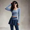 Nuevo traje deportivo de primavera y otoño, top cropped de manga larga y cuello redondo con bloques de color, conjunto de dos piezas de falda y pantalones de cintura alta para yoga