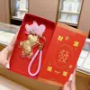 Llévate Riqueza Inmediatamente Set de Caja de Regalo Llavero Colgante Bolsa Dorada Accesorio Cadena de Teléfono Tienda de Transmisiones en Vivo de Tiktok Venta al por Mayor
