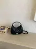 Al por mayor transfronterizo 2026 nuevo bolso de moda pequeño, bolso de media luna, bolso de mano acolchado elegante de alta gama, bolso de hombro y cruzado para mujer