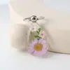 Amazon transfronterizo pegamento de color gota flor seca llavero creativo flor real hecho a mano resina colgante colgante joyería al por mayor