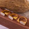 Anillo abierto ajustable con diseño de conchas marinas blancas retro europeas y americanas, anillo para mujer de acero de titanio, joyería de fábrica transfronteriza al por mayor
