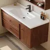 Tocador de baño de cerámica de color nogal estilo mid-century con lavabo integrado y espejo redondo