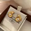 Pendientes Irregulares de Perla Brillante Estilo Exquisito Aroma Pequeño Moda Texturizada Europea y Americana Pendientes Minimalistas de Nicho para el Trabajo