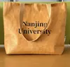 Bolsas de papel DuPont al por mayor, bolsas de tela tipo tote en blanco con logo impreso, bolsas de almacenamiento de gran capacidad, bolsas de papel kraft lavables