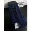 Pantalones de punto para hombre de otoño 2026 con un toque de alta gama, empalme de contraste de color, cintura elástica, pantalones casuales con un toque de alta gama