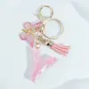 Suministra y Vende Llaveros con Alfabeto de 26 Letras en Forma de Corazón Rosa con Borlas de Mariposa, Colgantes para Llaves y Colgantes para Bolsos de Mujer