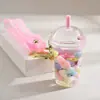 Famoso de Redes Sociales botella de arena movediza taza de té con leche llavero colgante creativo colgante de botella de arena movediza con aceite colgante pequeño para mochila escolar de estudiante