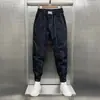 Pantalones casuales para hombre 2023 Verano nuevos holgados de seda de hielo finos guapos combinan con todo tobillo atado pantalones harén moda