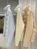Chaqueta de algodón con retazos de manga tejida estilo coreano para mujer, estilo corto, nuevo modelo de invierno 2026, cuello alto, abrigo ligero y versátil para personas menudas