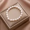Pulsera de cuerda elástica de cuentas de mijo de perlas de agua dulce naturales no se desvanece nicho super hada todo-combinable accesorios de pulsera de perlas