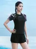 Nuevo traje de baño de mujer estilo tankini 2026, adelgazante y que esconde la barriga, de manga corta, adecuado para aguas termales, playa y vacaciones en resorts, conjunto de dos piezas