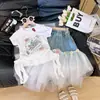 Conjunto de Falda de Mezclilla con Parches de Malla Irregular y Top Estampado de Manga Corta Nuevo Estilo Verano 2026 para Niñas