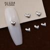 Nuevos accesorios de aleación para decoración de uñas con forma de corazón torcido tridimensional liso con diseño de amor hueco retro japonés