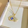 Collar de Acero de Titanio Ojo del Diablo con Goteo de Aceite Nuevo Producto Cruz Moda Femenina Versátil Cadena de Clavícula Ojos Azules Joyería con Sentido del Diseño
