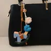 Miu Moda Tendência Couro Cavalo de Balanço Pingente Bola Trançada Fofo Versátil Nicho Bolsa Pingente Chaveiro