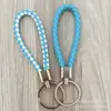Llavero de cuerda de cuero trenzado simple creativo colgante de muñeca linda accesorios de llave para parejas tendencia regalos pequeños venta al por mayor