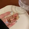 Pendientes de Nudo Dorados de Diseño de Nicho 2026 Nuevo Estilo Pendientes Elegantes para Sociales para Caras Redondas Que Hacen que la Cara Parezca Más Delgada, Pendientes de Alta Gama