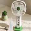 Ventilador de mano nuevo, simple y elegante, con rociador hidratante y tres velocidades de viento, que cuenta con una base de carga directa para teléfono, perfecto como ventilador de escritorio y como regalo