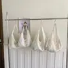 Bolsa de Ombro Única em Lona com Flor Vazada Feminina Grande Capacidade para o Trabalho Estilo Literário Versátil Bolsa Tote Verão 2026