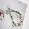 Moda coreana y japonesa Cadena de cuentas de plata versátil Colgante Etiqueta de corazón electrochapada Llavero Versión coreana Accesorio para bolso