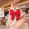 Llavero de Lujo Completo con Diamantes y Lazo de Cristal Sensación de Alta Gama Colgante de Bolso con Cadena de Perlas Tendencia de Moda Colgante de Pedrería