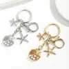 Temu AliExpress Llavero Colgante Estrella de Mar Perla Vieira Cruz Europea Americana Aleación Estrella de Mar Concha Accesorios para Bolsos