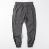 Venta al por mayor transfronterizaPantalones casuales finos de seda helada de verano para hombre Pantalones japoneses simples con tobillo atado elástico Pantalones cargo holgados